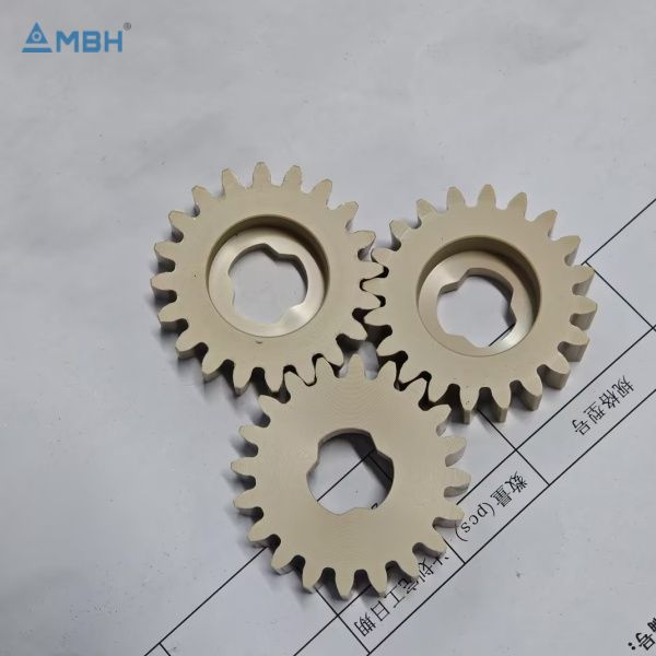 Three PEEK spur gears ivory white hexagonal bore 20 teeth triangular arrangement
